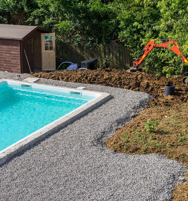 Piscine en construction avec excavatrice, abri de jardin et monticules de terre à Corme-Royal en Charente-Maritime 17